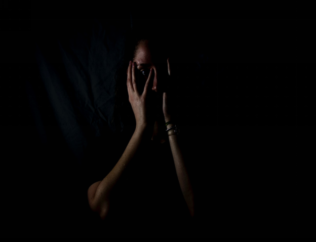 A Person Standing in Darkness